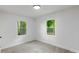 Bright bedroom featuring neutral walls, plush carpet, and windows with backyard views at 1750 Oak Valley Dr, Gastonia, NC 28054