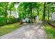 Exterior view of house surrounded by green trees and a long driveway at 1750 Oak Valley Dr, Gastonia, NC 28054