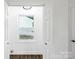 Hallway between rooms with hardwood-style flooring and window view at 1750 Oak Valley Dr, Gastonia, NC 28054