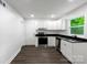 Featuring a sleek black stainless-steel range, this bright kitchen offers ample storage at 1750 Oak Valley Dr, Gastonia, NC 28054