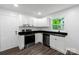 Renovated kitchen boasts white cabinets, granite counters, and stainless-steel appliances at 1750 Oak Valley Dr, Gastonia, NC 28054