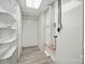 Basement with wood-look floors and utility features, ready for storage or customization at 202 Water Oak Dr, Pineville, NC 28134