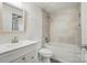 Bathroom showcases white vanity, tiled shower-tub combination, and modern fixtures at 202 Water Oak Dr, Pineville, NC 28134