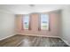 Bedroom featuring wood-look floors, and dual windows for natural light at 202 Water Oak Dr, Pineville, NC 28134