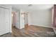 Bright bedroom offers wood-look floors, closet, and open doorway at 202 Water Oak Dr, Pineville, NC 28134