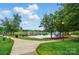 Picturesque lake view surrounded by green spaces and walking paths in a park-like setting at 202 Water Oak Dr, Pineville, NC 28134