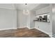 Bright dining area with wood floors, chandelier, and kitchen pass-through window at 202 Water Oak Dr, Pineville, NC 28134