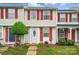 Charming townhouse featuring red shutters and a well-manicured front lawn at 202 Water Oak Dr, Pineville, NC 28134