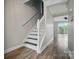 Hallway features stairs, wood-look floors, and neutral paint at 202 Water Oak Dr, Pineville, NC 28134