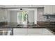 Kitchen features stainless steel sink, granite countertops, and open view to living area at 202 Water Oak Dr, Pineville, NC 28134