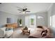 Comfortable living room showcasing modern decor, light gray walls, fan, and sliding glass doors to a balcony at 202 Water Oak Dr, Pineville, NC 28134