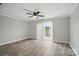 Open living room with wood floors and sliding glass doors to the outside patio at 202 Water Oak Dr, Pineville, NC 28134