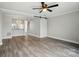 Open floor plan with wood floors, a barn door, and a view into the kitchen at 202 Water Oak Dr, Pineville, NC 28134