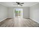 Open living room with wood floors and sliding glass doors to the outside patio at 202 Water Oak Dr, Pineville, NC 28134