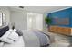 Spacious main bedroom features a wood accent wall, stylish furniture, and plenty of natural light at 202 Water Oak Dr, Pineville, NC 28134