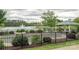 Community pond with fountain, gazebo and fence with manicured shrubbery at 202 Water Oak Dr, Pineville, NC 28134