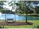 Picturesque community pond view with a swing and tree, perfect for relaxing outdoors at 202 Water Oak Dr, Pineville, NC 28134