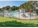 Community pool area with fencing and lounge chairs, perfect for relaxation and recreation at 202 Water Oak Dr, Pineville, NC 28134
