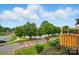 Scenic street view of a neighborhood with a lake and green trees, offering picturesque outdoor living at 202 Water Oak Dr, Pineville, NC 28134