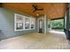 Inviting back porch with wood ceiling, recessed lighting, and fan at 2108 Lakeview Cir, Matthews, NC 28105