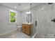 Modern bathroom with glass enclosed shower, neutral tiles, and sleek fixtures at 2108 Lakeview Cir, Matthews, NC 28105