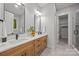 Bathroom featuring double vanity with modern faucets, mirrors, and a walk-in shower at 2108 Lakeview Cir, Matthews, NC 28105
