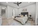 Serene bedroom with a black ceiling fan, natural light, and minimalist decor at 2108 Lakeview Cir, Matthews, NC 28105
