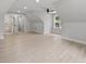 A spacious bonus room features neutral tones and plenty of natural light from large windows at 2108 Lakeview Cir, Matthews, NC 28105