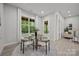 Cozy dining area with a glass table, modern chairs, and natural light from the window at 2108 Lakeview Cir, Matthews, NC 28105