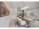 Bright dining room showcases a modern chandelier and seamlessly connects to the living areas at 2108 Lakeview Cir, Matthews, NC 28105