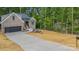 Well-designed house featuring a long driveway, a two-car garage, and manicured landscaping at 2108 Lakeview Cir, Matthews, NC 28105