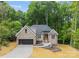 Lovely home featuring landscaped front yard, two-car garage and a mix of brick and siding at 2108 Lakeview Cir, Matthews, NC 28105
