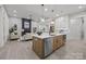 Open-concept kitchen features a large island with seating and seamlessly connects to the living area at 2108 Lakeview Cir, Matthews, NC 28105
