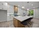 Bright kitchen features white cabinets, a large island with seating, and stainless steel appliances at 2108 Lakeview Cir, Matthews, NC 28105