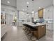 Modern kitchen features a large island with seating, stylish pendant lights, and stainless steel appliances at 2108 Lakeview Cir, Matthews, NC 28105