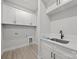 Functional laundry room with white cabinets, countertop space, and modern fixtures for easy chores at 2108 Lakeview Cir, Matthews, NC 28105