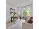 Bright and airy home office space with a large window, desk, and cozy seating area at 2108 Lakeview Cir, Matthews, NC 28105