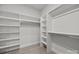 Spacious walk-in closet with built-in shelving and ample hanging space for organized storage at 2108 Lakeview Cir, Matthews, NC 28105