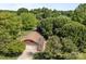 Aerial view of property highlighting the roof, driveway, and surrounding mature trees at 250 Log Barn Rd, Salisbury, NC 28146