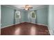 Bright bedroom with two windows, hardwood floors, and neutral paint at 250 Log Barn Rd, Salisbury, NC 28146