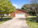 A brick two-car garage with a concrete driveway surrounded by lush landscaping and mature trees at 250 Log Barn Rd, Salisbury, NC 28146