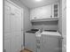 Well-organized laundry room with cabinetry above washer and dryer units for storage solutions at 250 Log Barn Rd, Salisbury, NC 28146