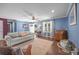 Inviting living room featuring hardwood floors, a comfortable sofa, and ample natural light at 250 Log Barn Rd, Salisbury, NC 28146