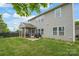 Large backyard with green grass, a screened-in patio, and an outdoor grill, great for entertaining at 306 Fesperman Cir, Troutman, NC 28166
