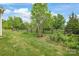 Picturesque backyard with lush green lawn, a wooden fence, and mature trees offering privacy and shade at 306 Fesperman Cir, Troutman, NC 28166