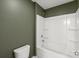 Modern bathroom featuring a white tub and shower combination and olive-green colored walls at 306 Fesperman Cir, Troutman, NC 28166