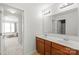 Bright bathroom with double sinks, modern fixtures, and an open doorway at 306 Fesperman Cir, Troutman, NC 28166