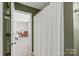 Bathroom with neutral carpet and view into bedroom with bed at 306 Fesperman Cir, Troutman, NC 28166