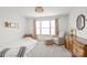 Bright bedroom with a comfortable chair, wooden dresser, and window providing ample natural light at 306 Fesperman Cir, Troutman, NC 28166