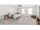 Bedroom with neutral carpet, ceiling fan, and natural light from two windows at 306 Fesperman Cir, Troutman, NC 28166